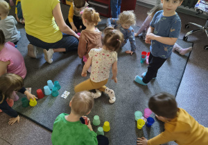 Dzieci układają kolorowe kubeczki według wzoru.