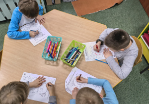 Starszaki wykonują kartę pracy.