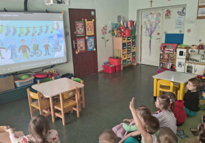 Dzieci oglądają prezentację multimedialną.